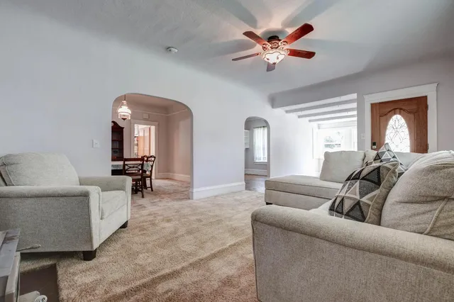 a view of a dining room with furniture and a chandelier