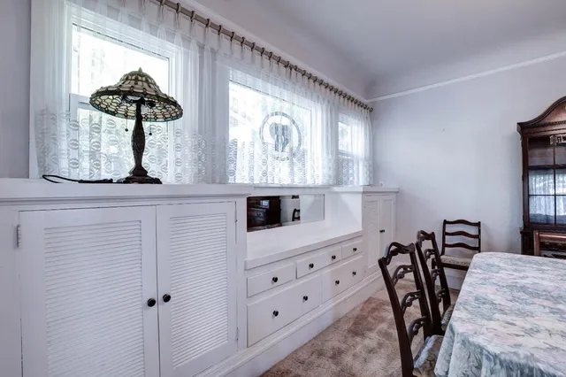 a kitchen with stainless steel appliances granite countertop wooden cabinets a stove a sink and a microwave