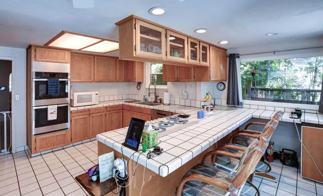 a kitchen with a sink and a stove top oven
