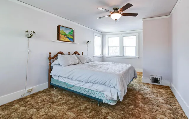 a bathroom with a granite countertop toilet sink and mirror