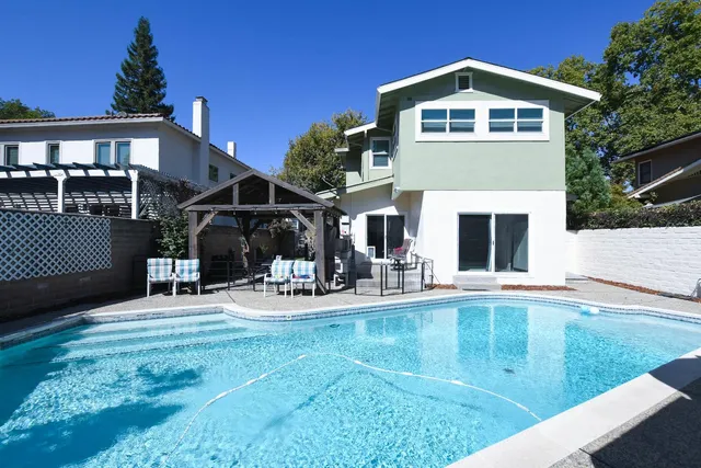 a view of a table and chairs in backyard