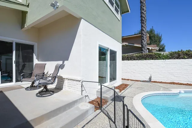 an aerial view of a house with a swimming pool