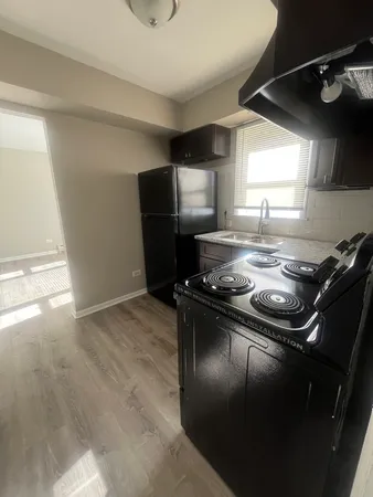 a kitchen with a stove and a refrigerator