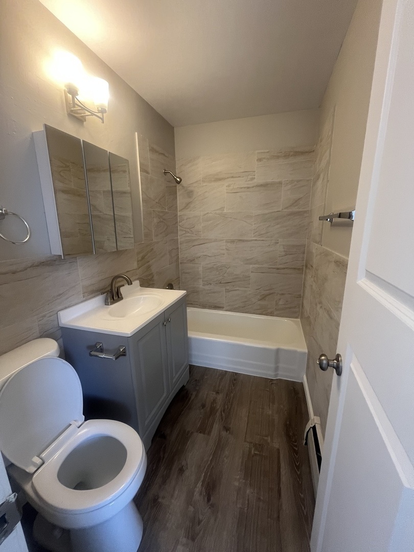 1340 North Main Street, Unit E4 Wheaton, IL 60187 - Photo 7 of 7 a bathroom with a sink and mirror