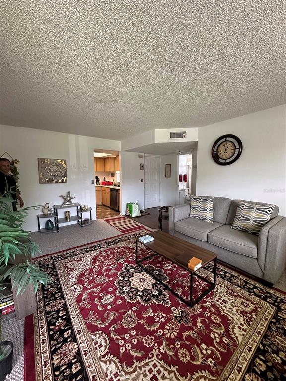 584 Fairways Lane, Unit F202 Ocala, FL 34472 - Photo 11 of 17 a living room with furniture and a rug