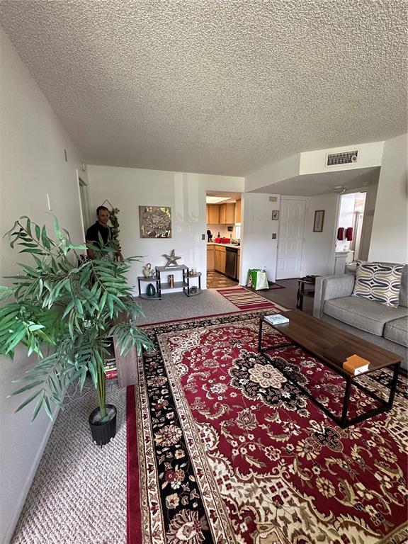 584 Fairways Lane, Unit F202 Ocala, FL 34472 - Photo 12 of 17 a living room with furniture and a rug
