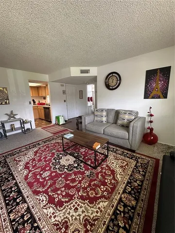a living room with furniture and a rug