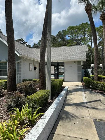 a view of a house with a garden and pathway