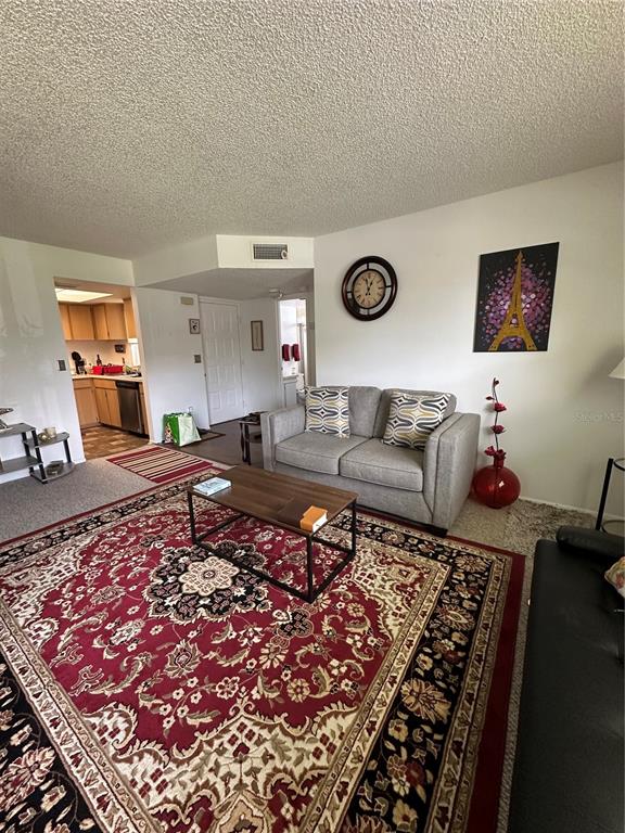 584 Fairways Lane, Unit F202 Ocala, FL 34472 - Photo 7 of 17 a living room with a couch and a rug
