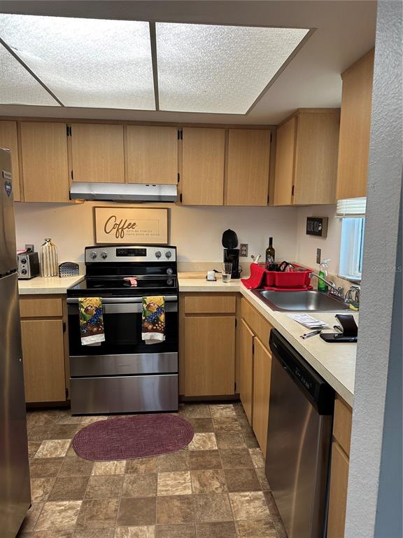 584 Fairways Lane, Unit F202 Ocala, FL 34472 - Photo 8 of 17 a kitchen with a stove microwave and cabinets