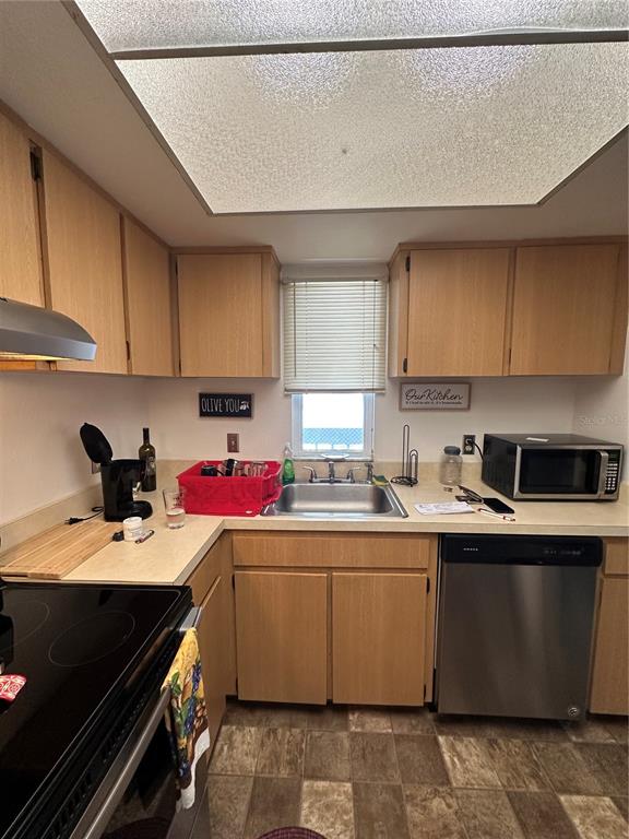 584 Fairways Lane, Unit F202 Ocala, FL 34472 - Photo 9 of 17 a kitchen with a sink a stove and cabinets