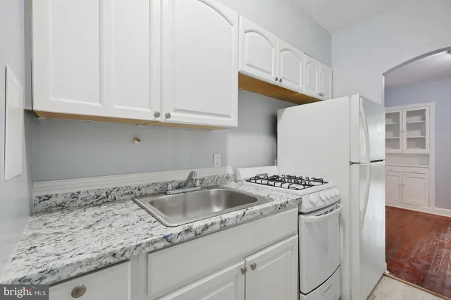 a kitchen that has a sink and a stove