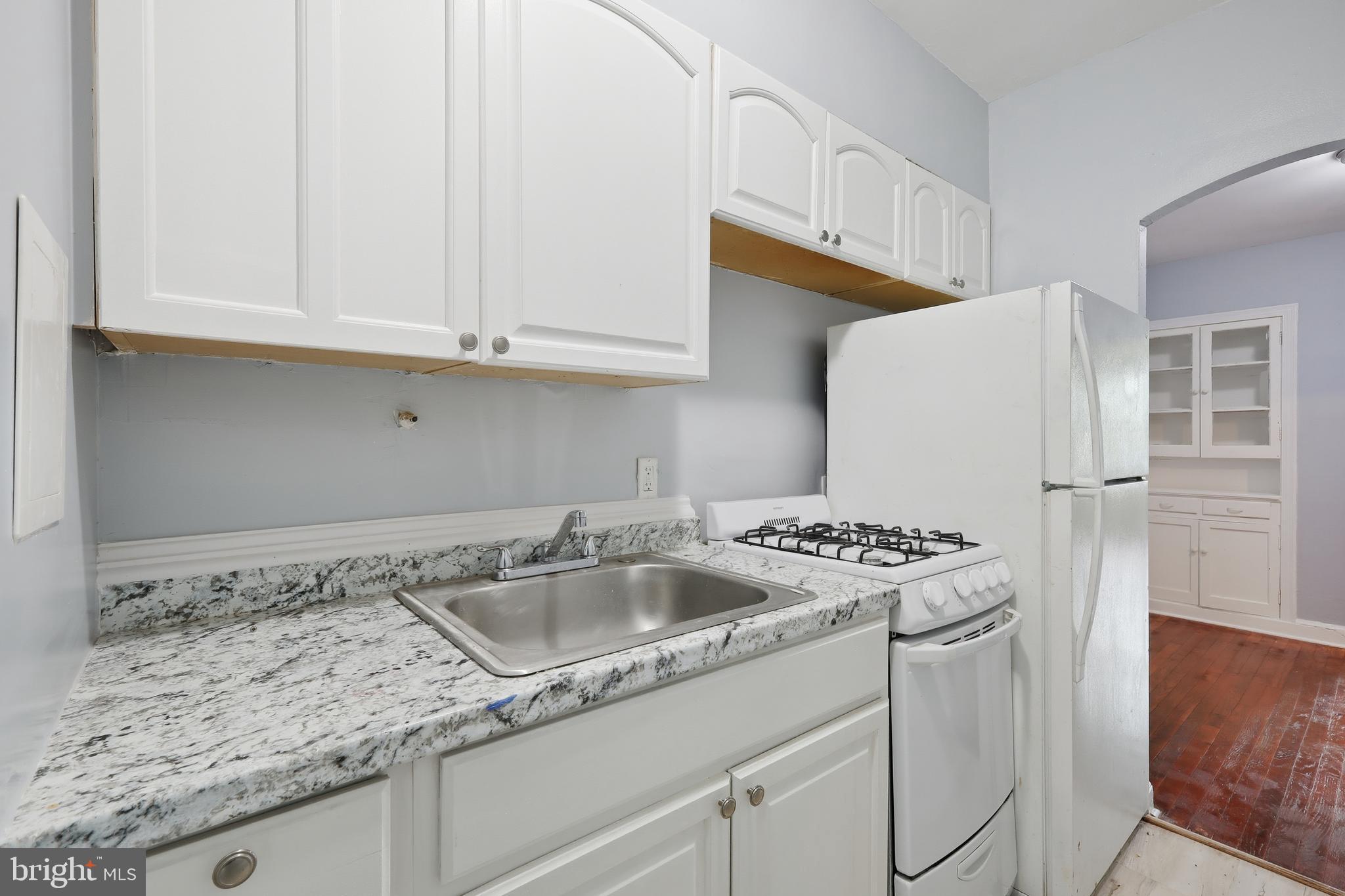 3919 R Street Southeast, Unit 2 Washington, DC 20020 - Photo 14 of 41 a kitchen that has a sink and a stove