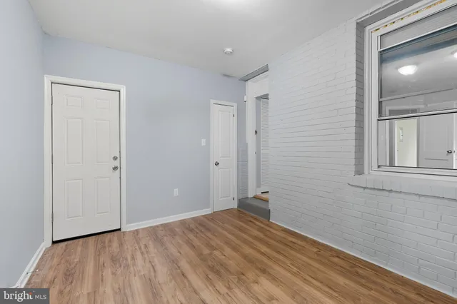a view of a room with wooden floor and bathroom