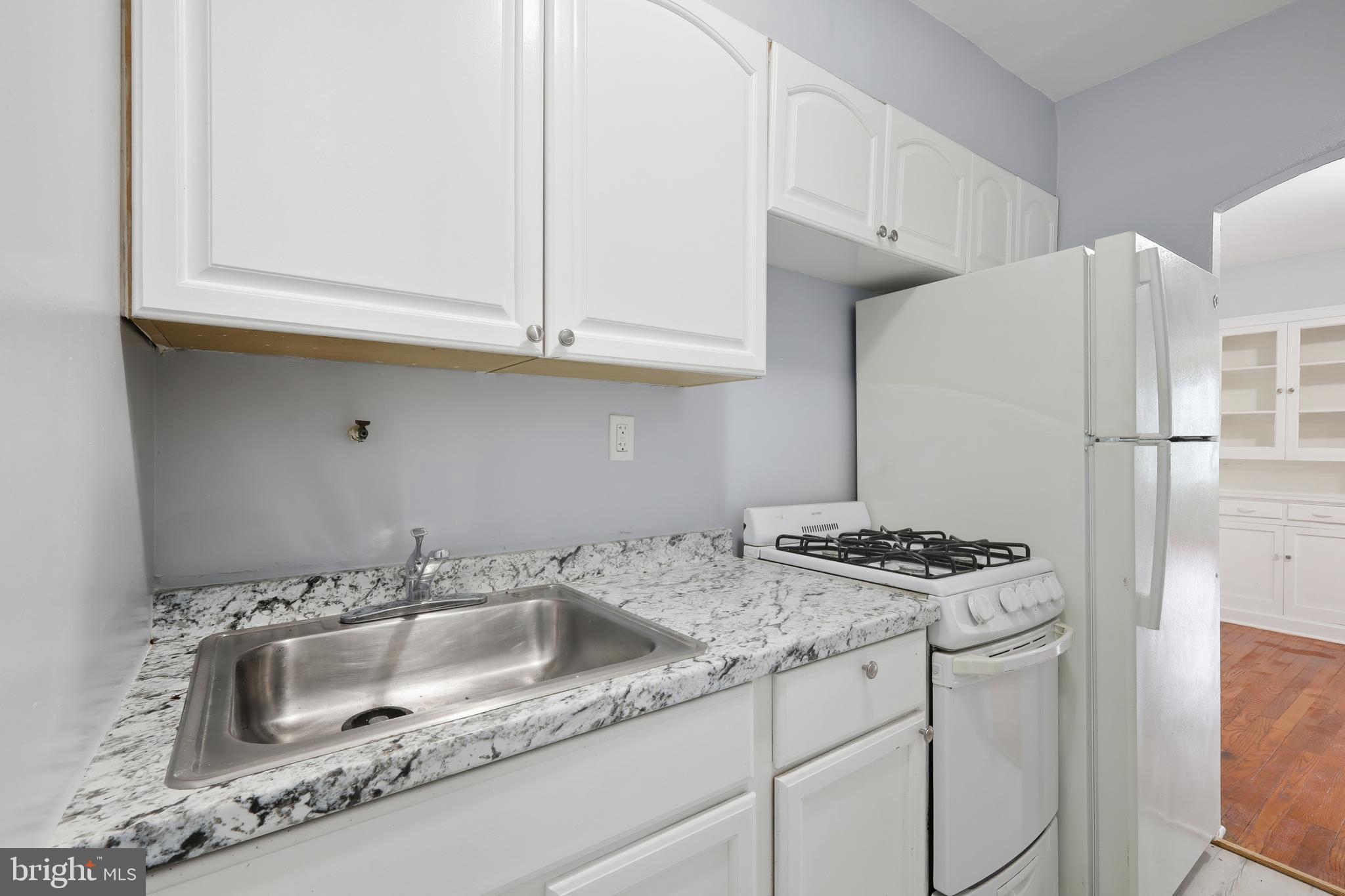 3919 R Street Southeast, Unit 2 Washington, DC 20020 - Photo 23 of 41 a kitchen with stainless steel appliances granite countertop a sink stove and cabinets
