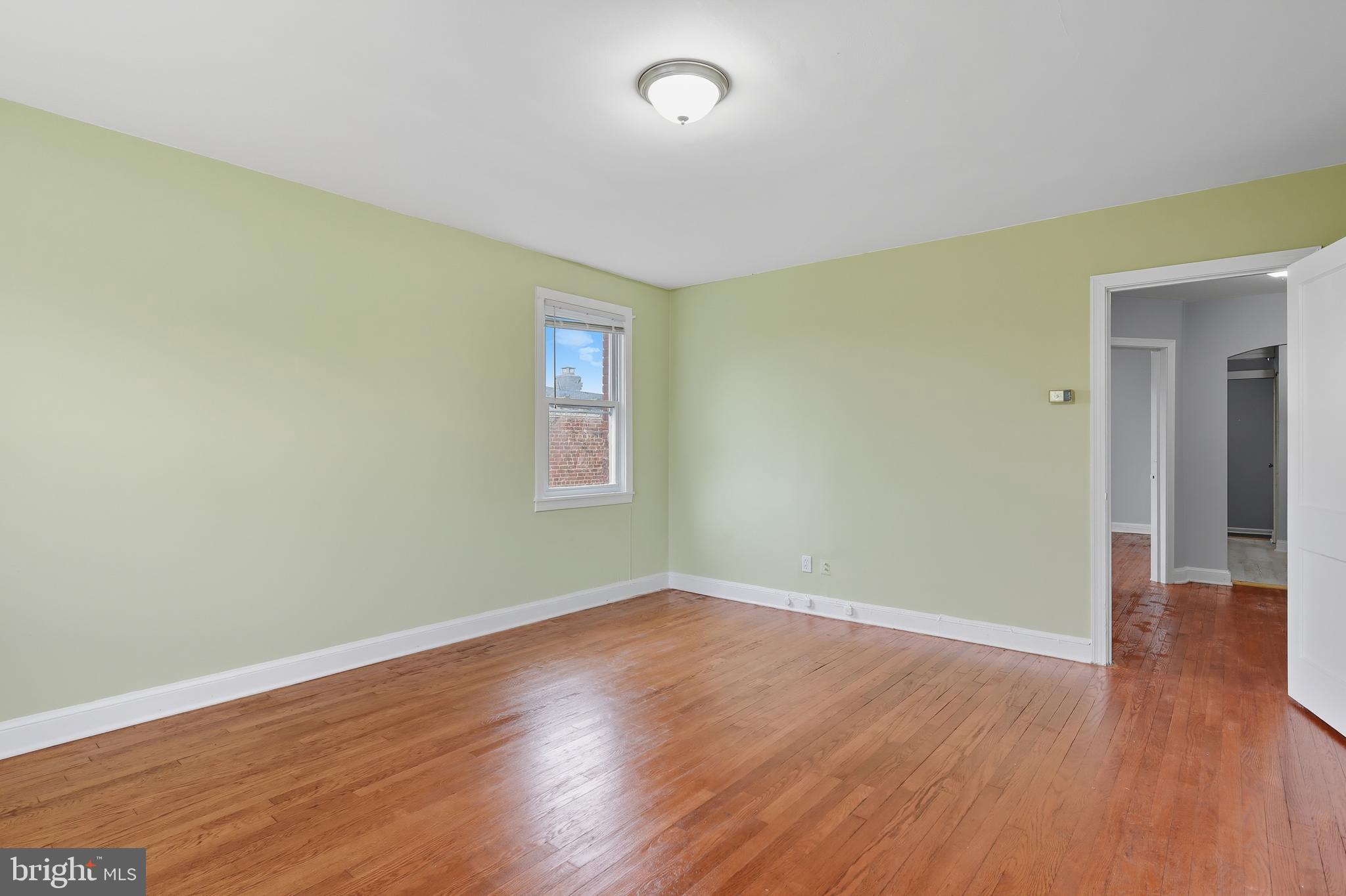3919 R Street Southeast, Unit 2 Washington, DC 20020 - Photo 28 of 41 an empty room with wooden floor and windows