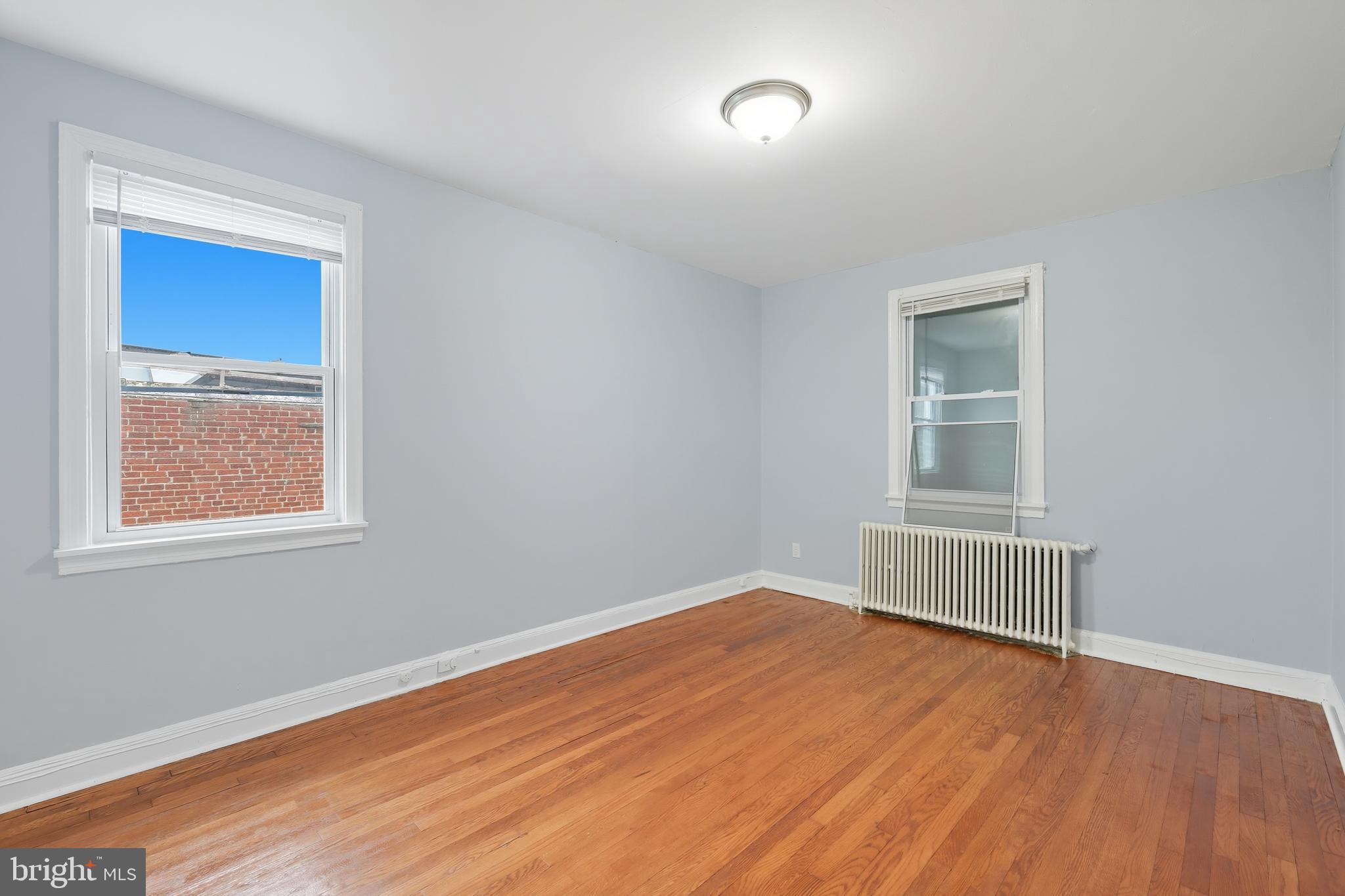 3919 R Street Southeast, Unit 2 Washington, DC 20020 - Photo 32 of 41 an empty room with wooden floor and windows