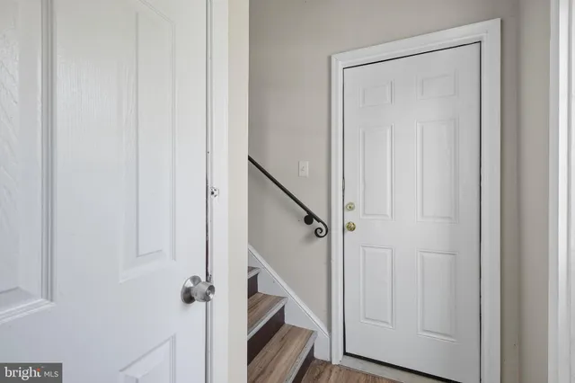 a view of a hallway with wooden floor and entryway