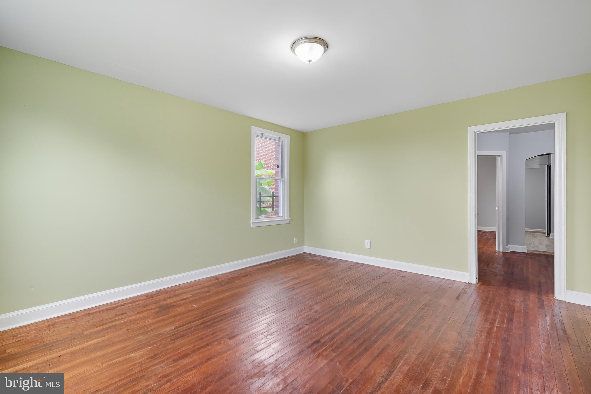 3919 R Street Southeast, Unit 2 Washington, DC 20020 - Photo 5 of 41 an empty room with wooden floor and windows