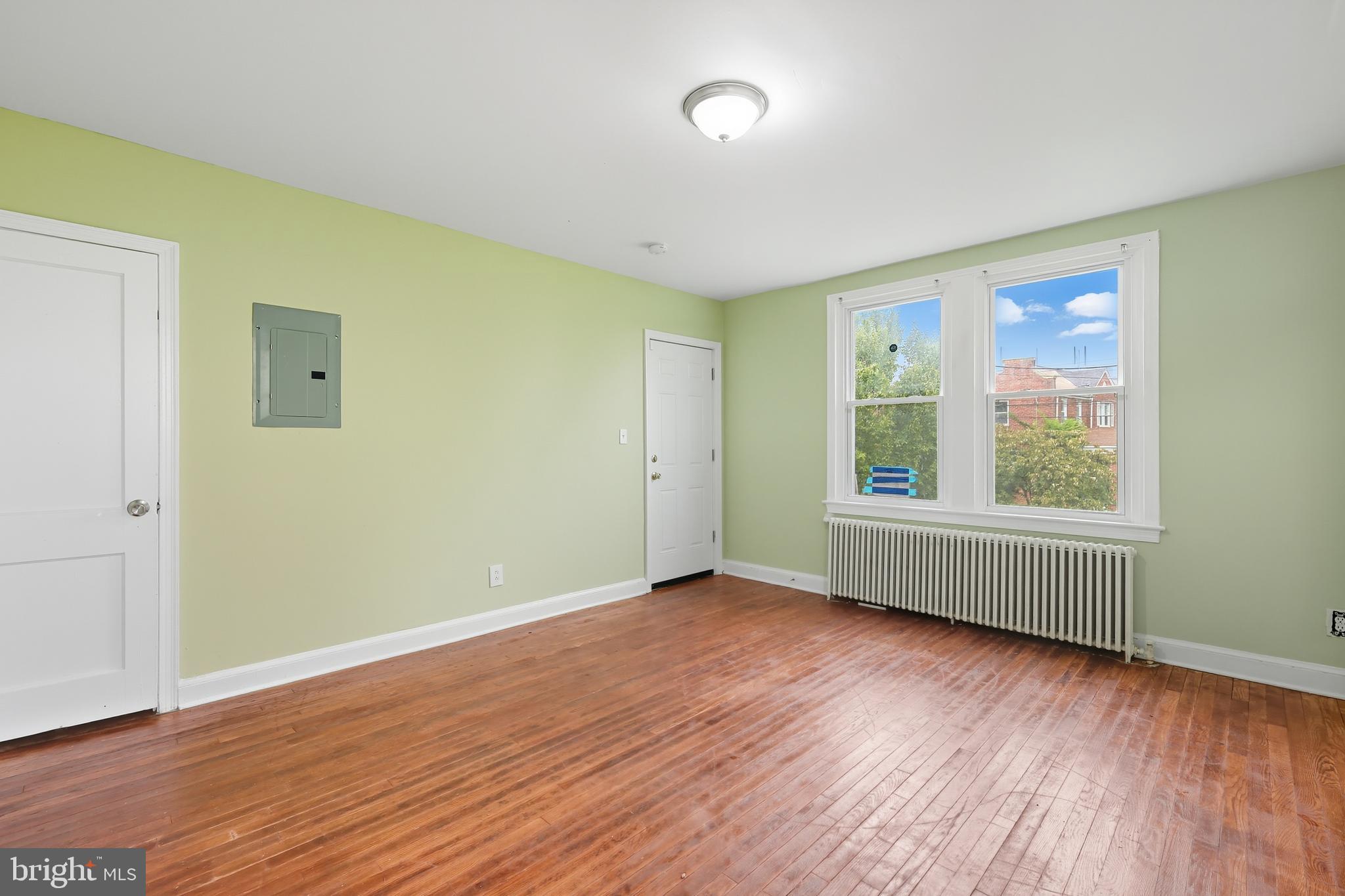 3919 R Street Southeast, Unit 2 Washington, DC 20020 - Photo 6 of 41 an empty room with wooden floor and windows