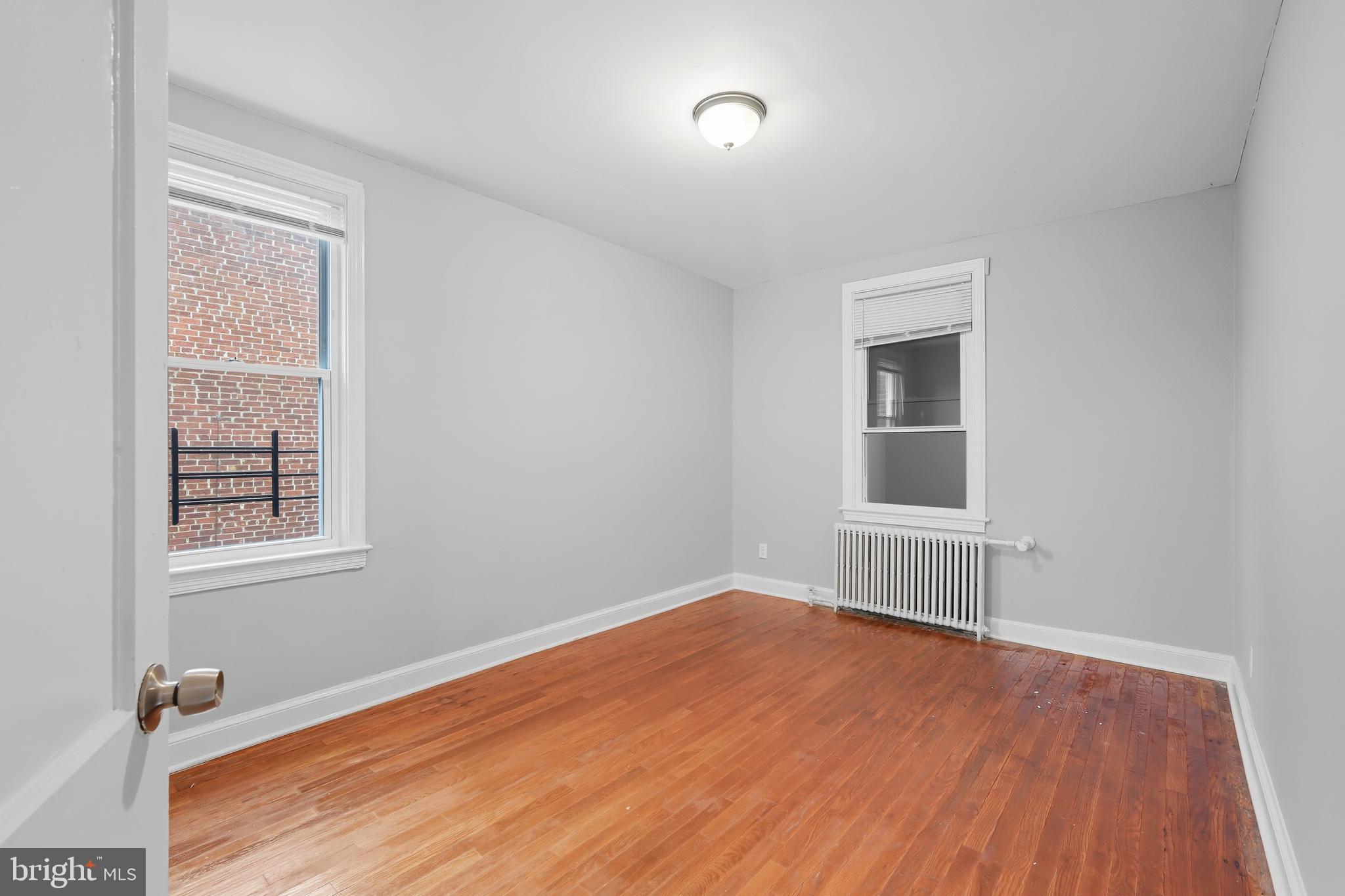 3919 R Street Southeast, Unit 2 Washington, DC 20020 - Photo 8 of 41 an empty room with wooden floor and windows
