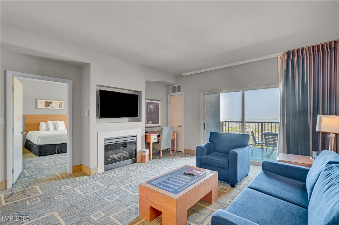 211 East Flamingo Road, Unit 1211 Las Vegas, NV 89169 - Photo 6 of 22 Living area showing TV, fireplace and work corner