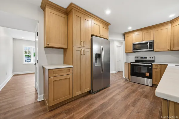 a kitchen with stainless steel appliances a refrigerator and a stove top oven