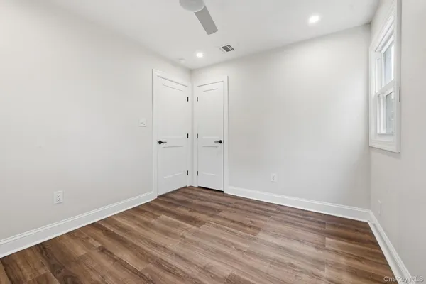 a view of room with wooden floor