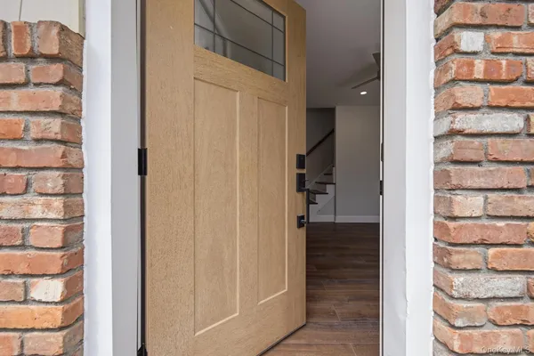 a view of a bedroom with wooden floor and entryway