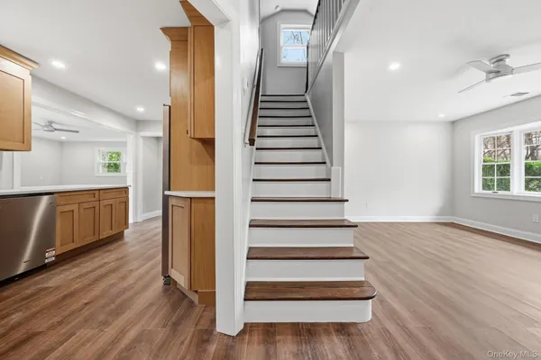 a view of entryway and hall with wooden floor