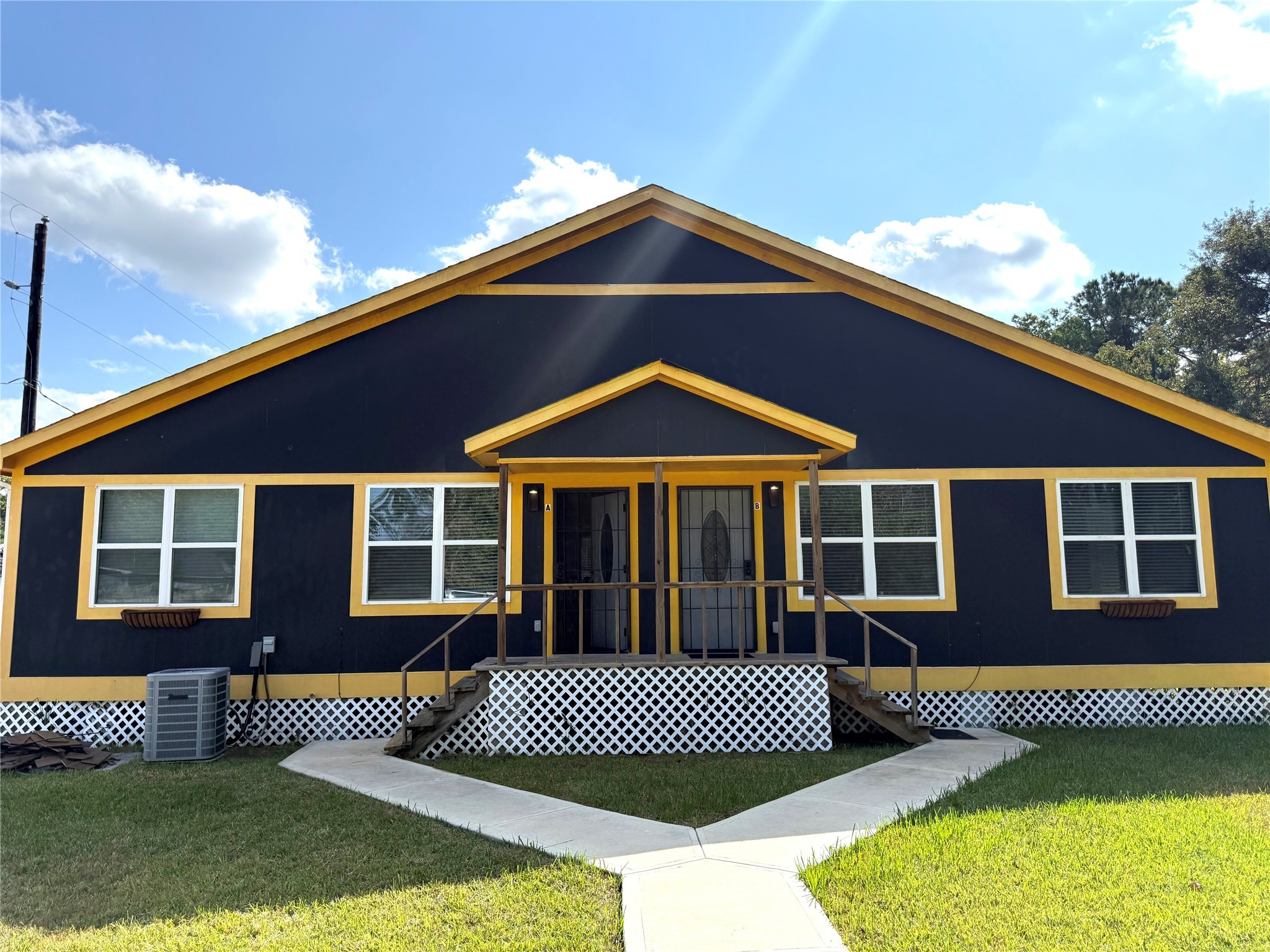 a front view of a house with a garden