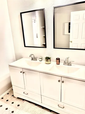 a bathroom with a sink a mirror and a shower