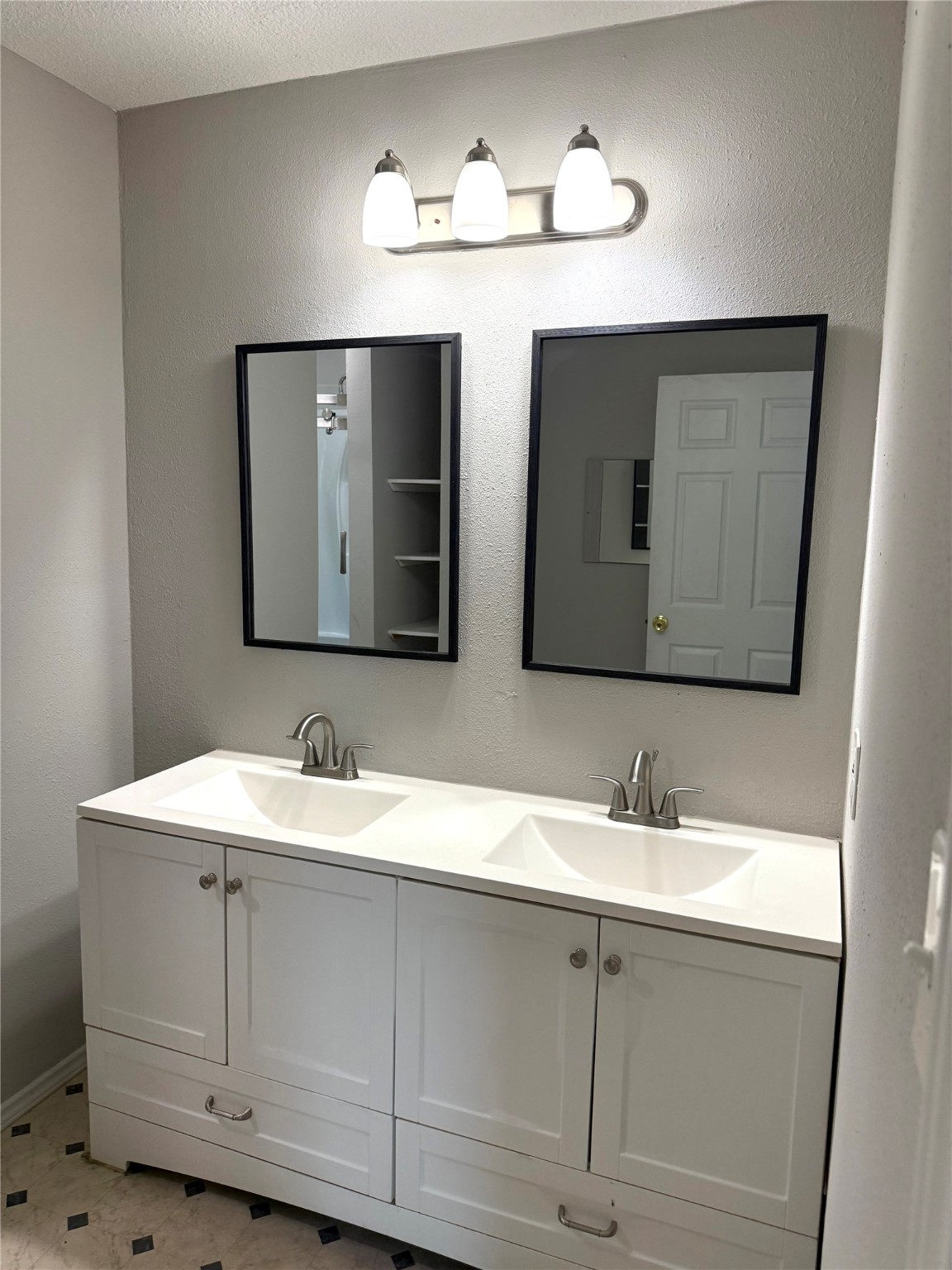 9822 Candy Court, Unit B Spring, TX 77379 - Photo 13 of 27 a bathroom with a double vanity sink and a mirror