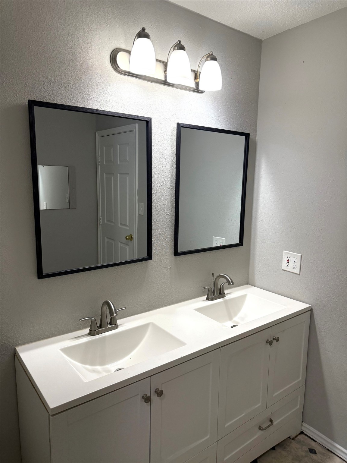 9822 Candy Court, Unit B Spring, TX 77379 - Photo 14 of 27 a bathroom with a sink and a mirror