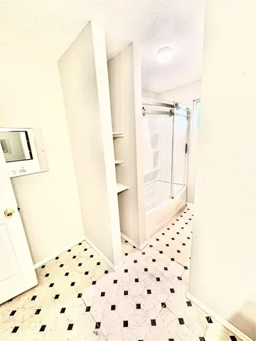 a bathroom with a bathtub and a shower