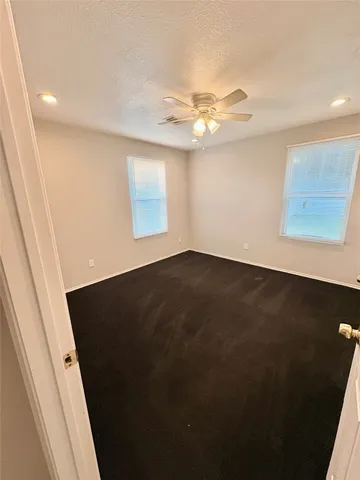 a kitchen with stainless steel appliances kitchen island granite countertop a refrigerator and microwave