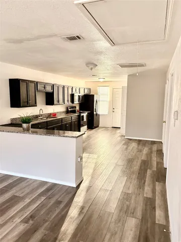 a bathroom with a granite countertop sink and mirror