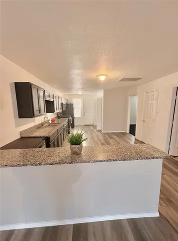 a kitchen view with wooden cabinets and stainless steel appliances