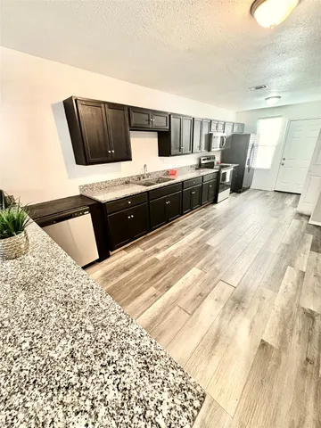 a kitchen with a stove and a microwave