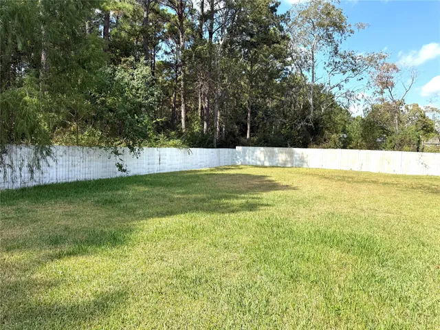 a swimming pool with trees in the background