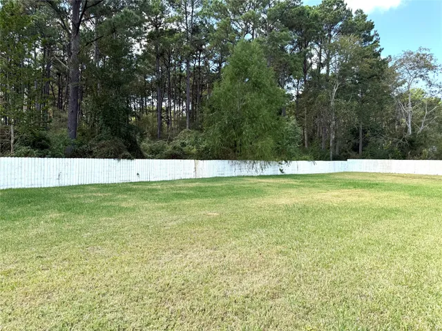 a view of a brick wall with wooden fence