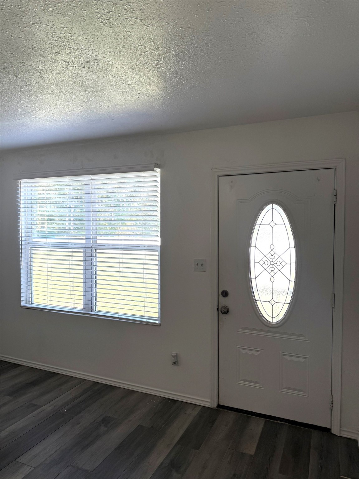 9822 Candy Court, Unit B Spring, TX 77379 - Photo 4 of 27 an empty room with wooden floor and windows