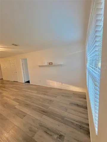 a view of a room with wooden floor