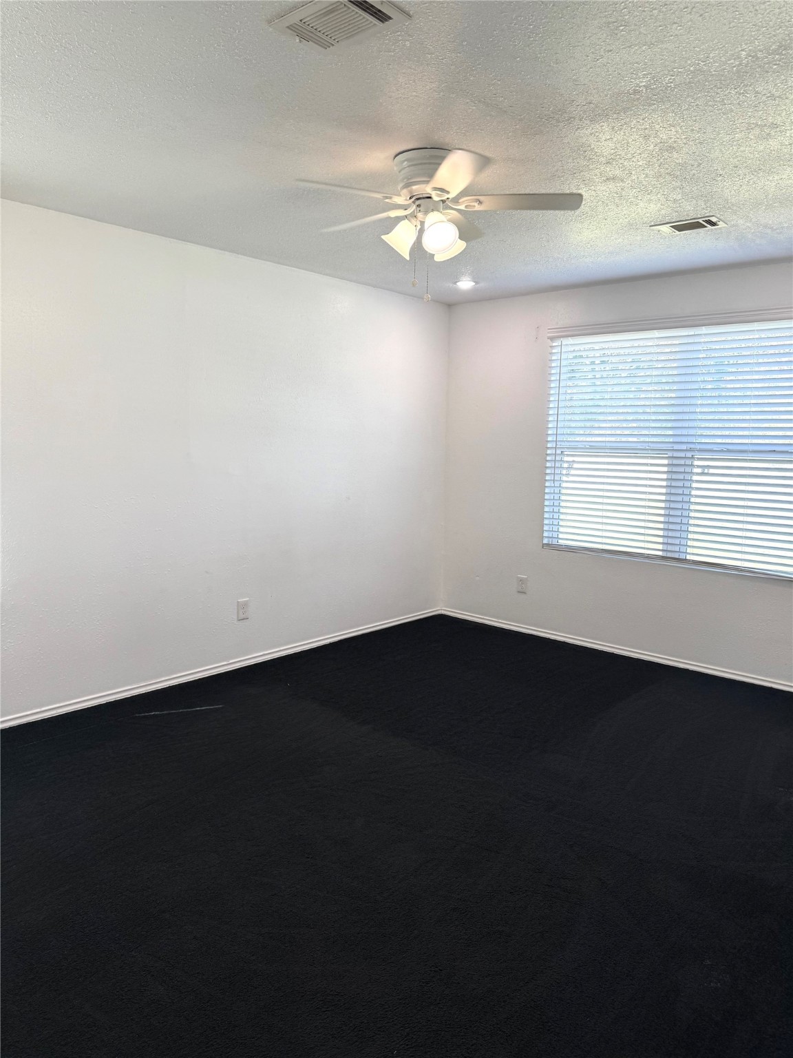 9822 Candy Court, Unit B Spring, TX 77379 - Photo 9 of 27 a view of an empty room with wooden floor and a window