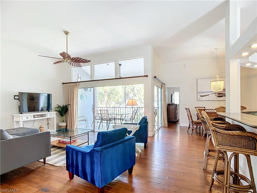 2860 Citrus Lake Drive, Unit R202 Naples, FL 34109 - Photo 13 of 50 a living room with furniture and a flat screen tv