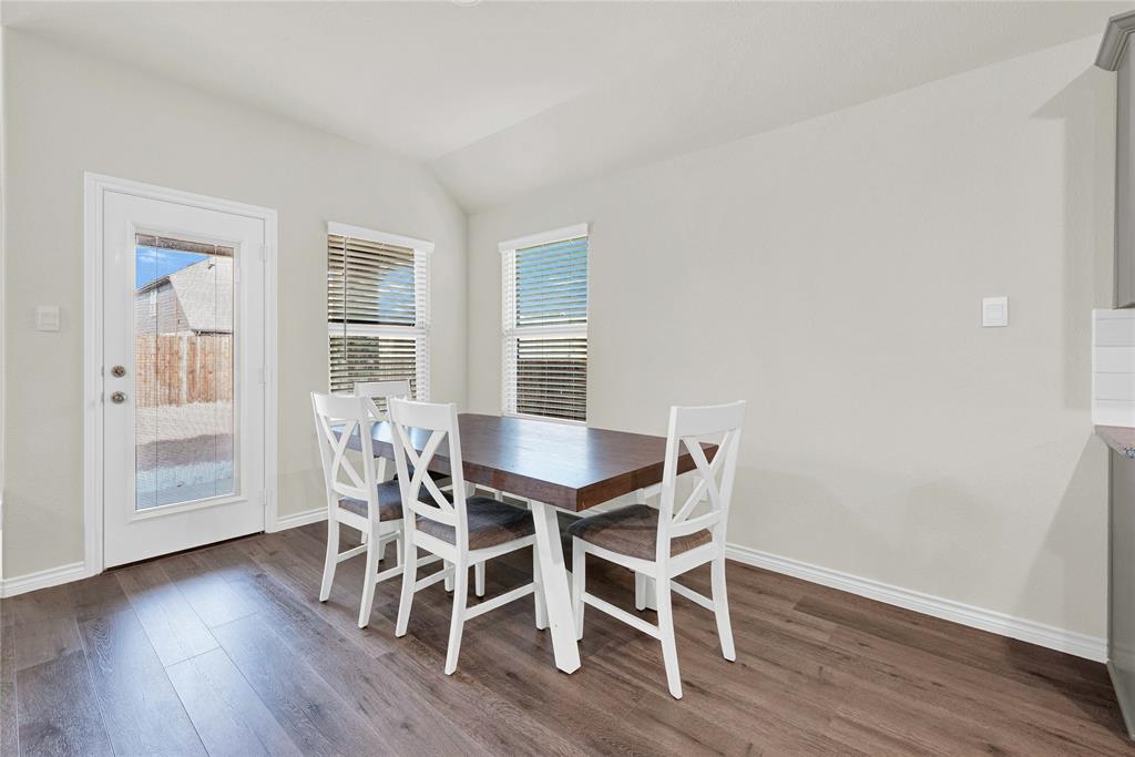 9713 Quail Pointe Road Aubrey, TX 76227 - Photo 11 of 23 Dining area with healthy amount of natural light, dark wood-style floors, and vaulted ceiling
