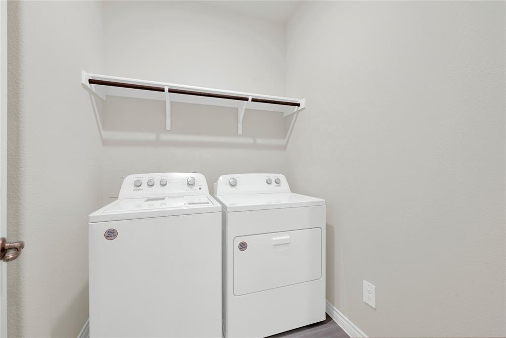 9713 Quail Pointe Road Aubrey, TX 76227 - Photo 14 of 23 Laundry room with independent washer and dryer and wood finished floors