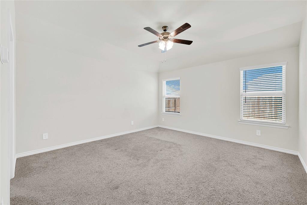 9713 Quail Pointe Road Aubrey, TX 76227 - Photo 15 of 23 Unfurnished room with light colored carpet and ceiling fan