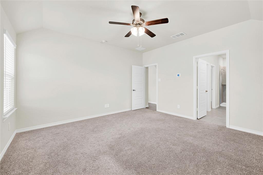 9713 Quail Pointe Road Aubrey, TX 76227 - Photo 16 of 23 Unfurnished bedroom featuring lofted ceiling, light carpet, and ceiling fan
