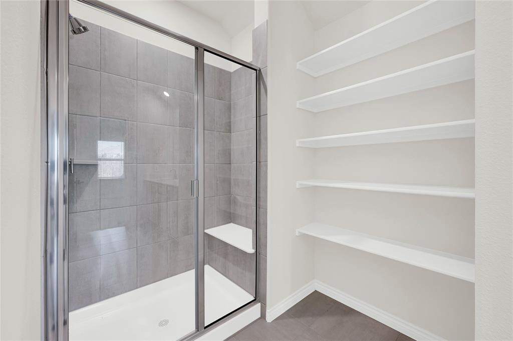 9713 Quail Pointe Road Aubrey, TX 76227 - Photo 18 of 23 Full bathroom with a shower stall and baseboards